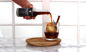 cold brew coffee with ice ball citrus rosemary cinnamon stick